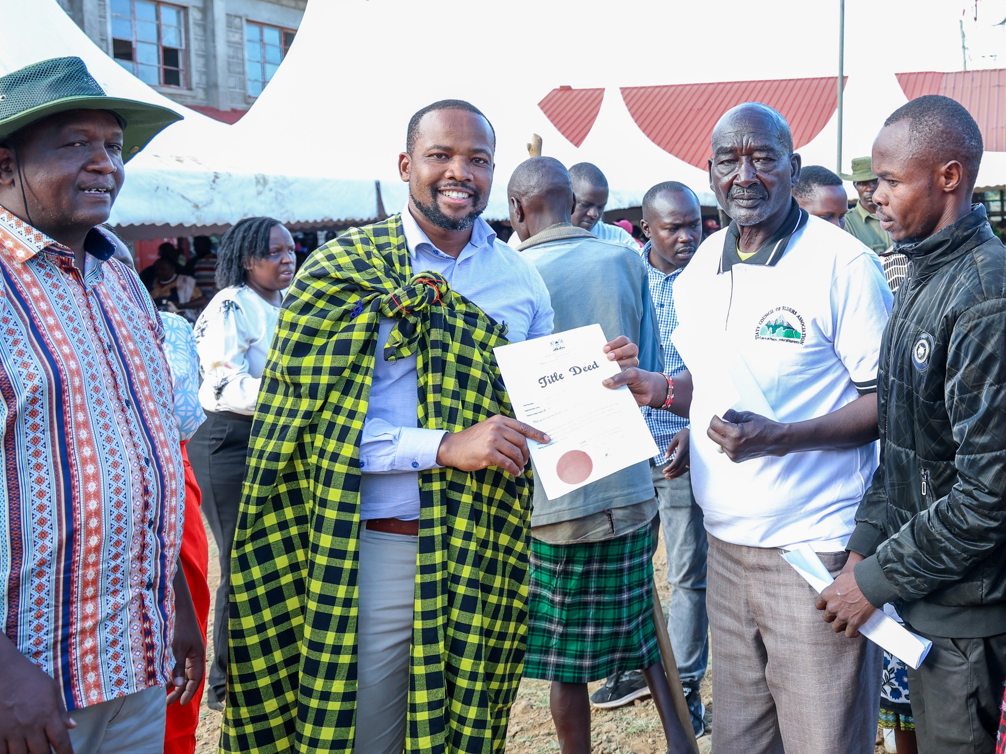 Lands Principal Secretary Generali Nixon Koriri issues title deed to a resident of Churo/Amaya Ward in Tiaty Constituency.