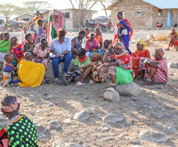 Assistant Director of Land Adjudication and Settlement, Joyce Kamire, with women parting in the exercise at Olturot